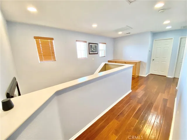 a view of a kitchen with wooden floor and a sink