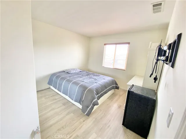 a bedroom with a bed and a mirror