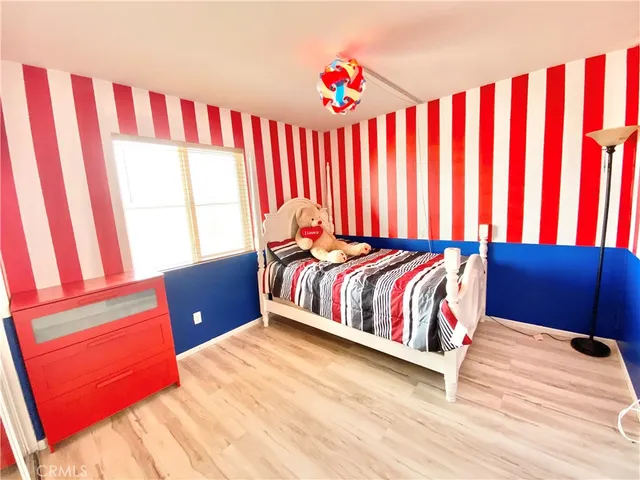 a bed room with a bed and a chair