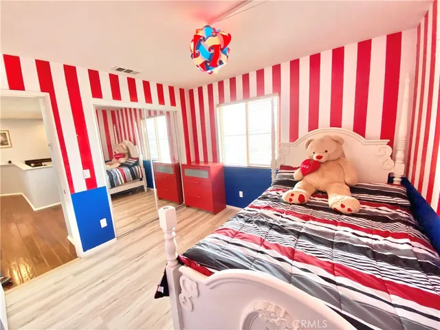 a bedroom with a bed and a potted plant