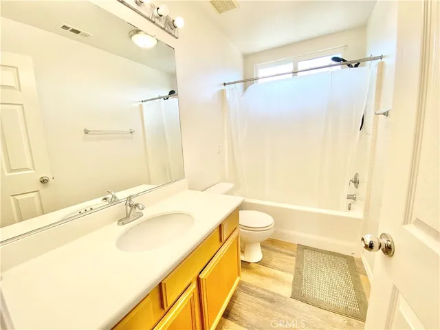a bathroom with a sink mirror toilet and shower