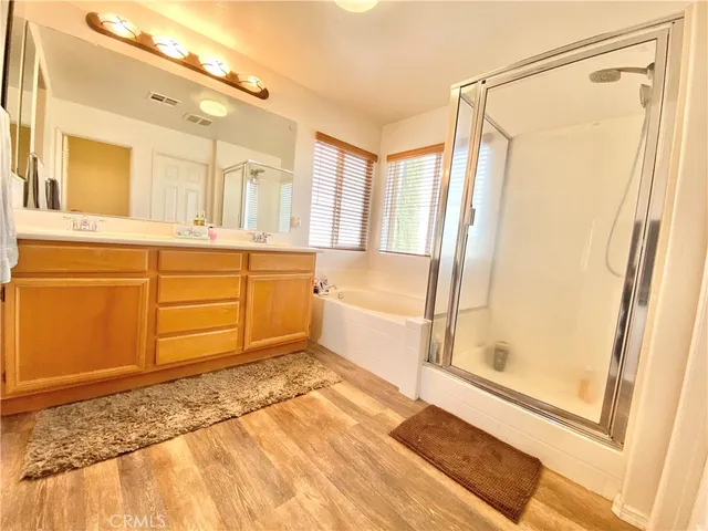 a bathroom with a tub sink and shower