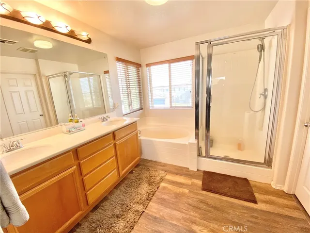 a bathroom with a tub sink and mirror