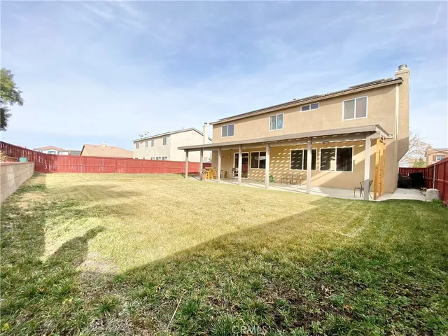 a house view with swimming pool in front of it