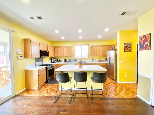 a large kitchen with a table and chairs