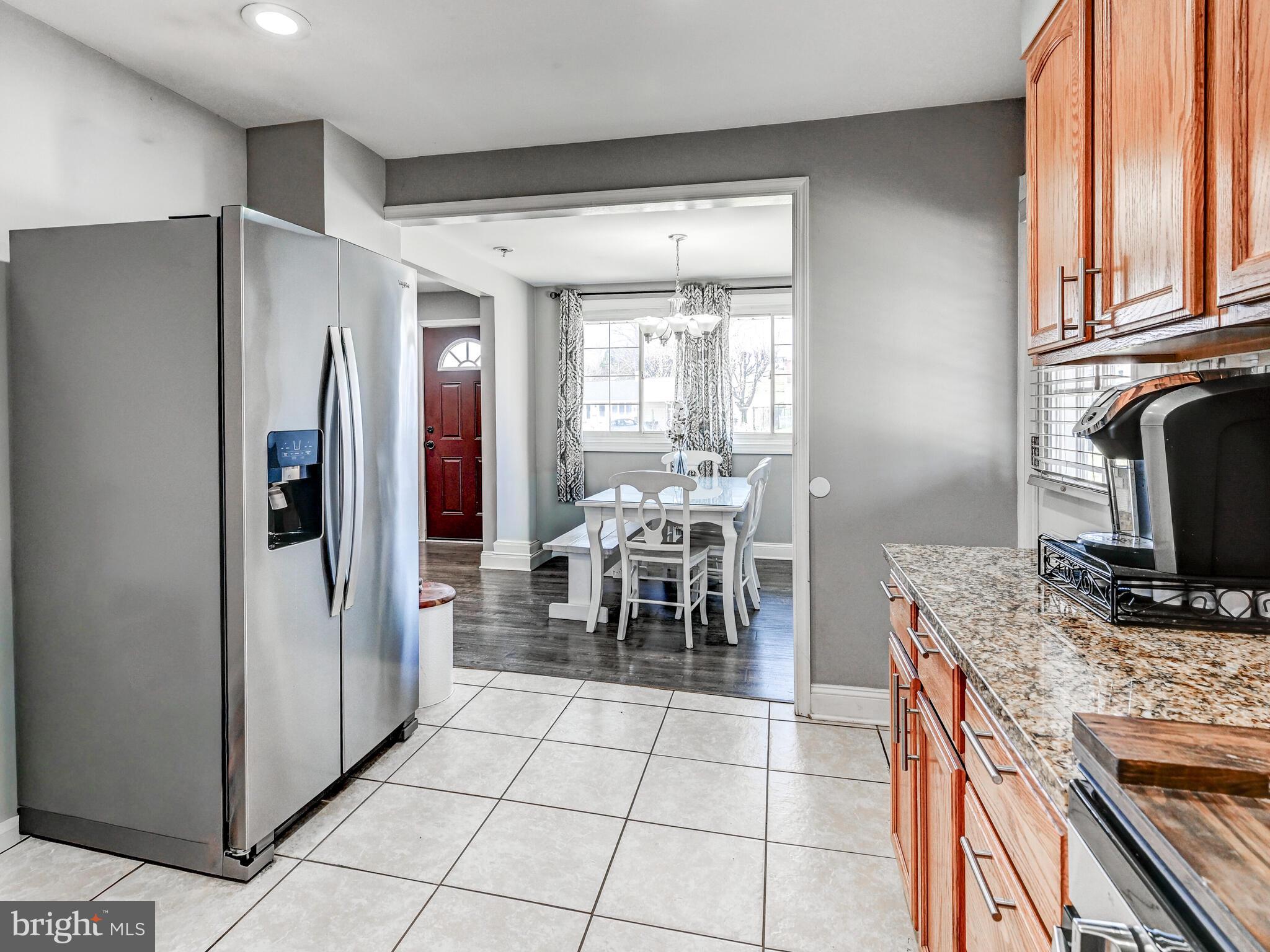 2712 Burridge Road Baltimore, MD 21234 - Photo 15 of 32 a kitchen with granite countertop a refrigerator and a stove top oven