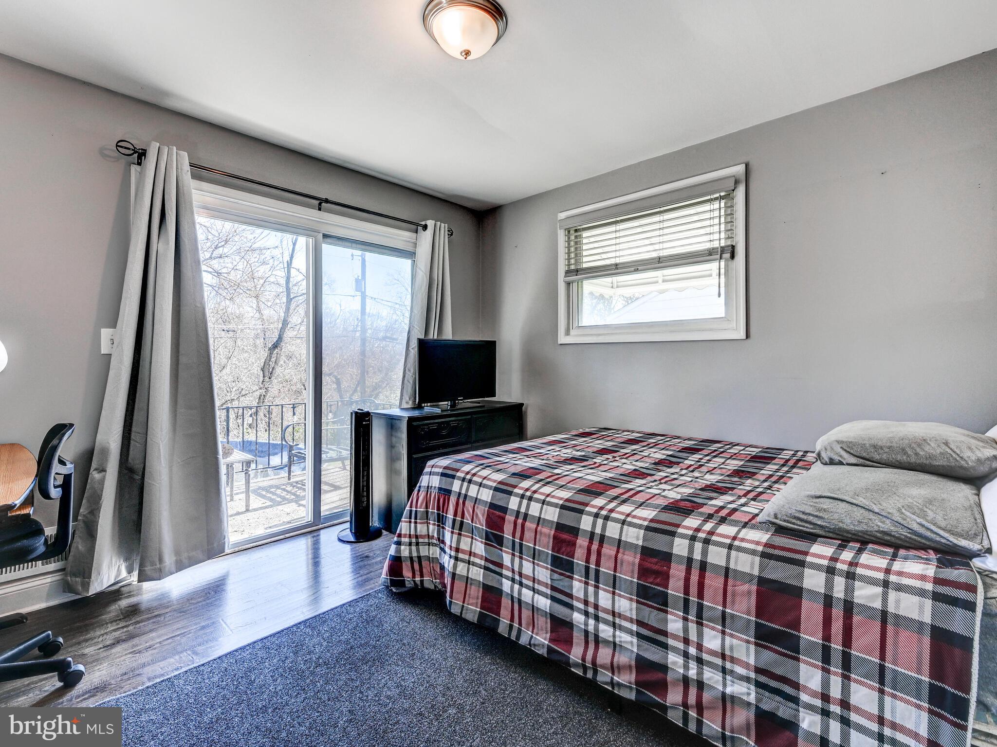 2712 Burridge Road Baltimore, MD 21234 - Photo 20 of 32 a bedroom with a bed and a flat tv screen on a dresser