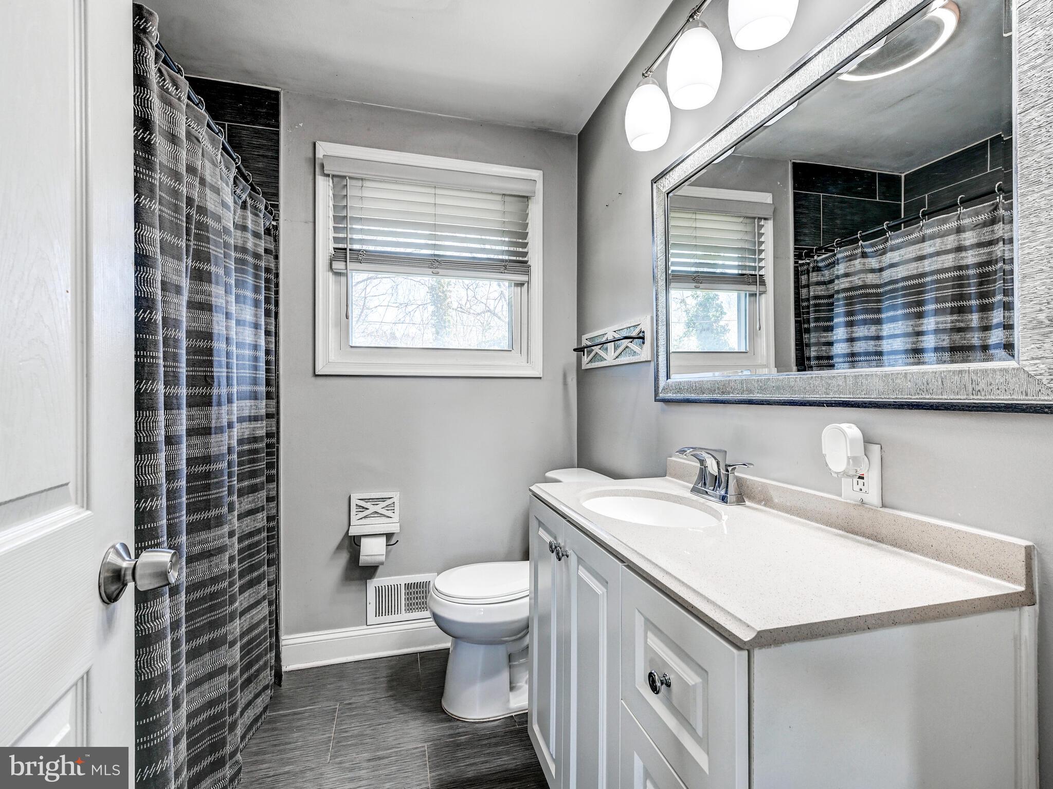 2712 Burridge Road Baltimore, MD 21234 - Photo 23 of 32 a bathroom with a sink toilet and mirror