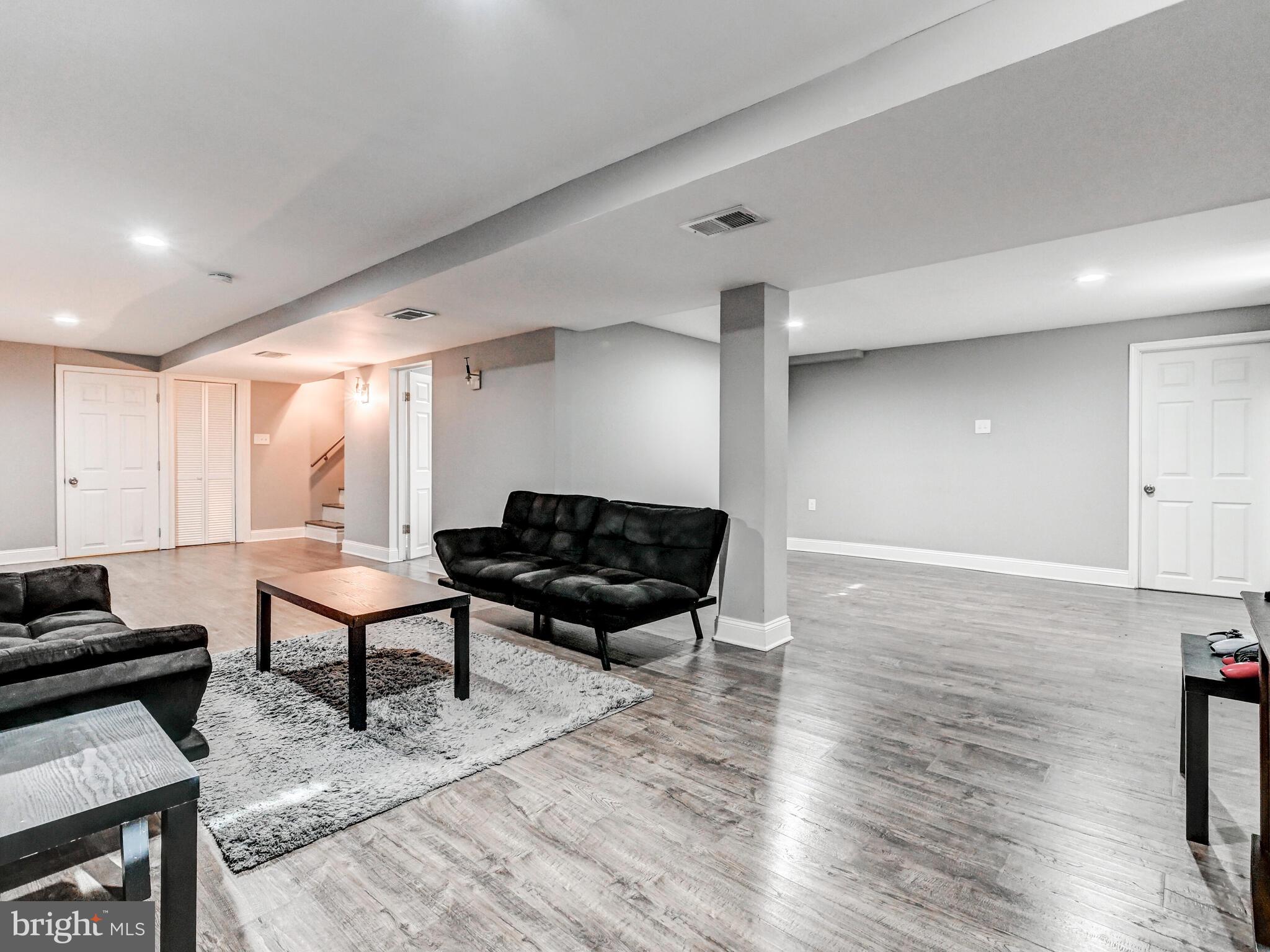 2712 Burridge Road Baltimore, MD 21234 - Photo 25 of 32 a living room with furniture a wooden floor and a potted plant