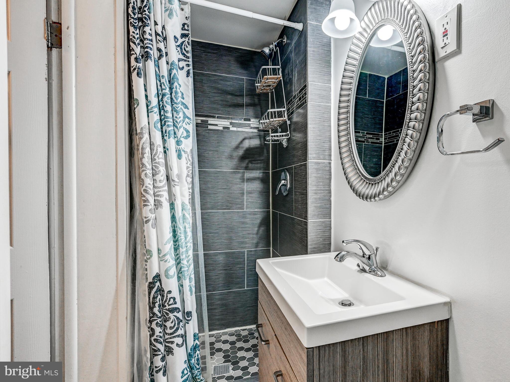 2712 Burridge Road Baltimore, MD 21234 - Photo 27 of 32 a bathroom with a sink a toilet and shower
