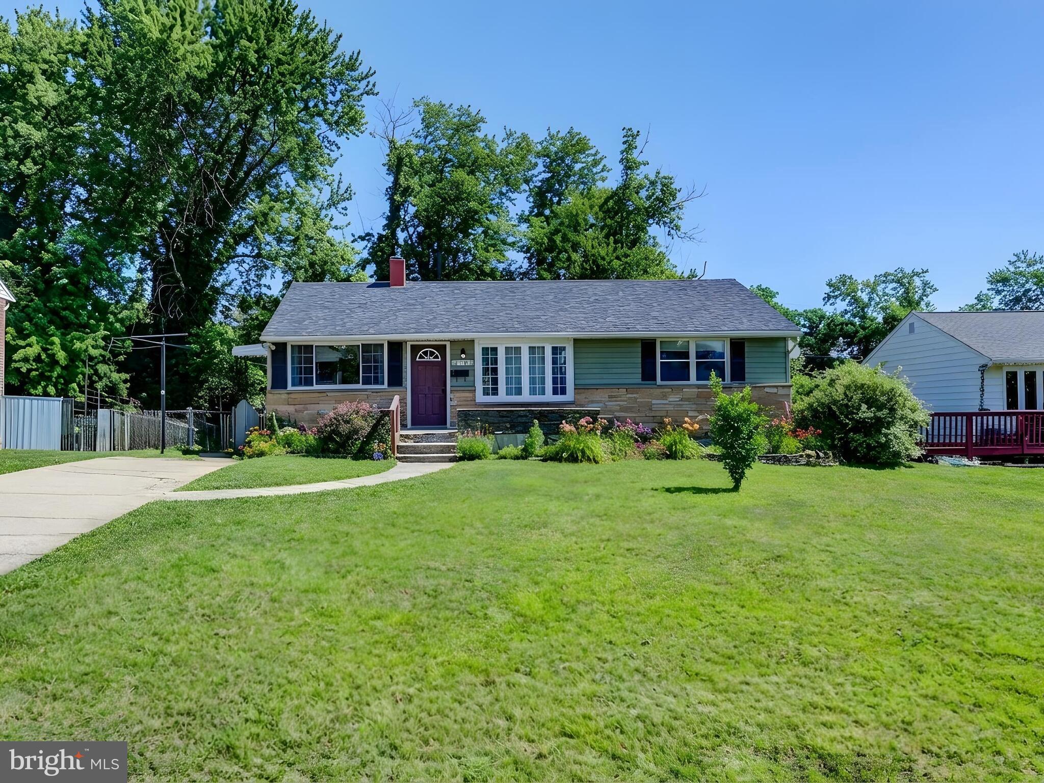 2712 Burridge Road Baltimore, MD 21234 - Photo 32 of 32 a front view of a house with a yard and trees