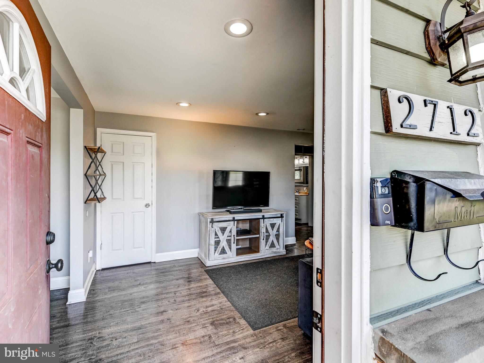 2712 Burridge Road Baltimore, MD 21234 - Photo 7 of 32 a view of a livingroom with wooden floor and furniture