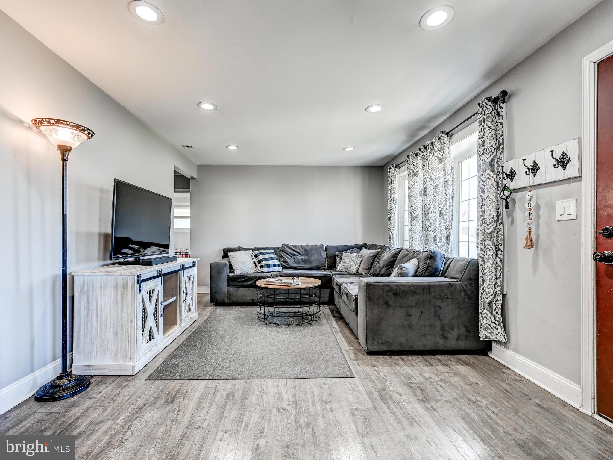 2712 Burridge Road Baltimore, MD 21234 - Photo 8 of 32 a living room with furniture and a flat screen tv