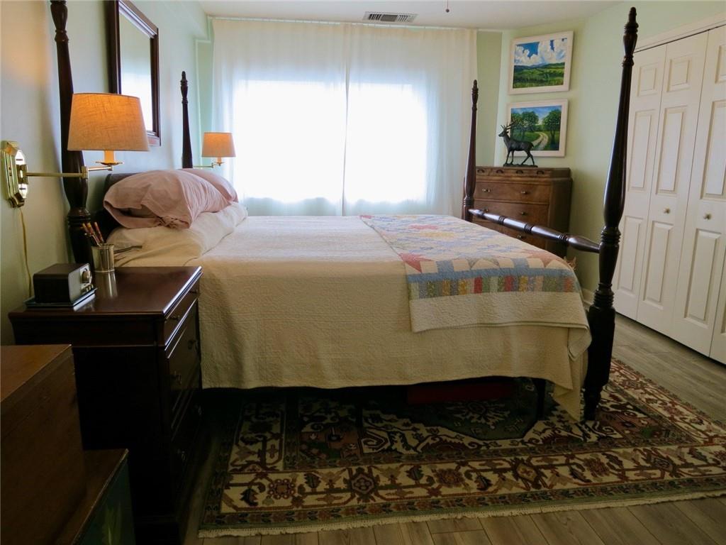 1501 Clairmont Road, Unit 713 Decatur, GA 30033 - Photo 14 of 29 a bedroom with a bed and wooden floor