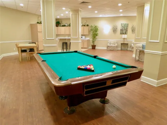 a kitchen with a table chairs and a refrigerator