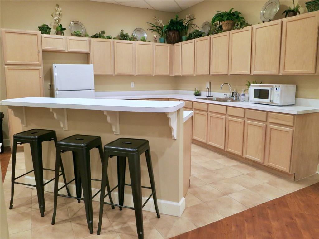 1501 Clairmont Road, Unit 713 Decatur, GA 30033 - Photo 23 of 29 a kitchen with a table chairs and a refrigerator
