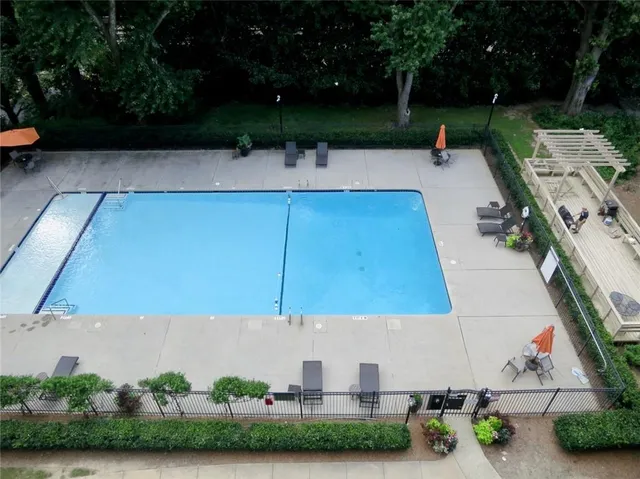 a view of a terrace with a bench and trees