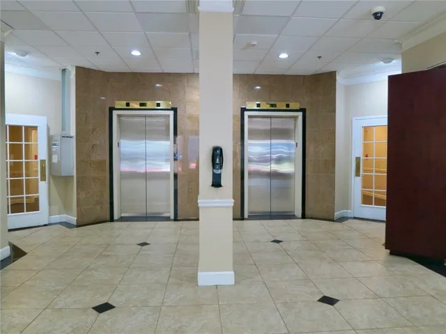 a view of a hallway with wooden cabinets