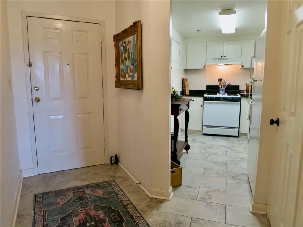 1501 Clairmont Road, Unit 713 Decatur, GA 30033 - Photo 8 of 29 a kitchen with a refrigerator and white cabinets