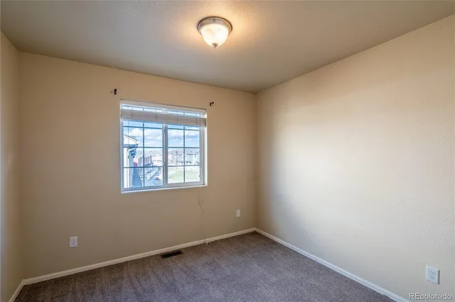 an empty room with a empty space and windows