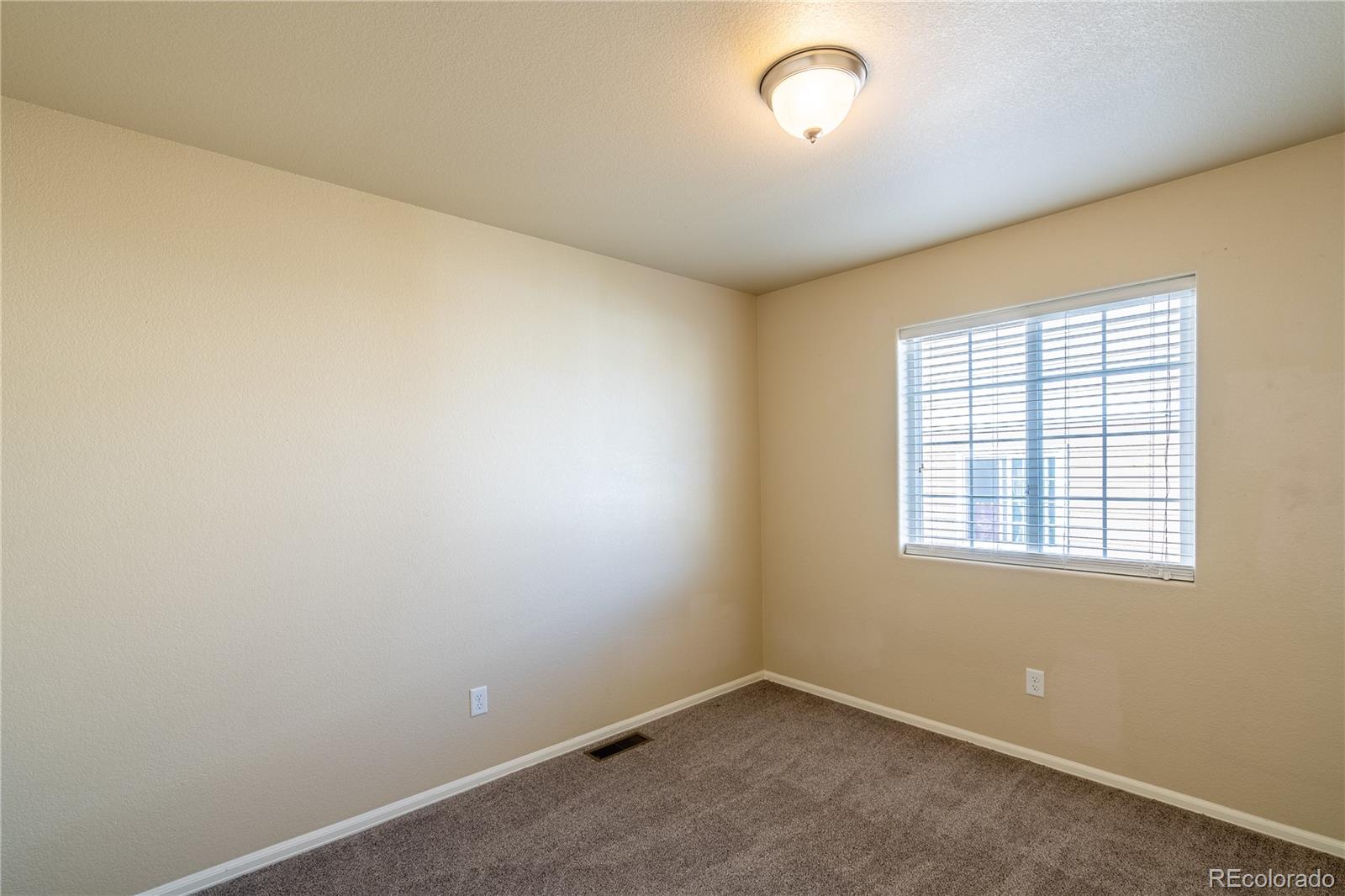 4910 Pearl Kite View Colorado Springs, CO 80916 - Photo 12 of 16 an empty room with a empty space and windows