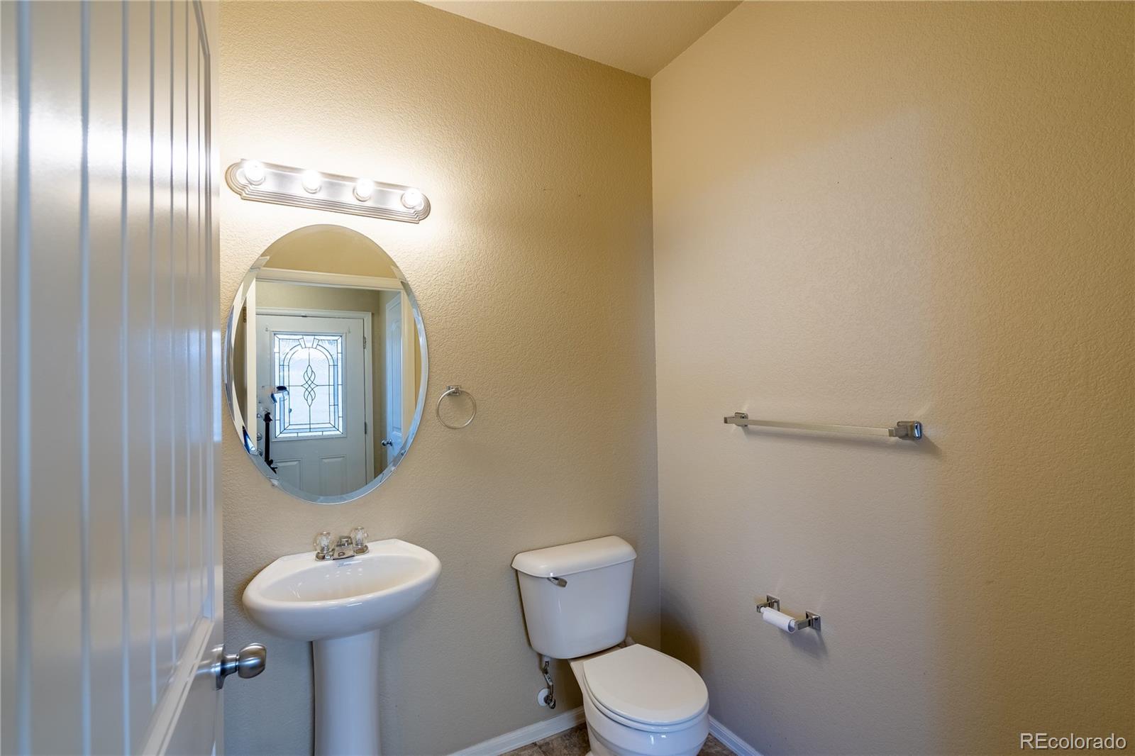 4910 Pearl Kite View Colorado Springs, CO 80916 - Photo 13 of 16 a bathroom with a toilet sink and mirror