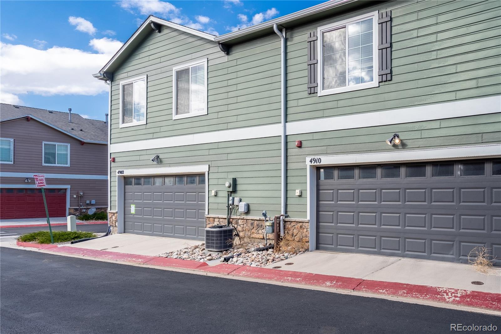 4910 Pearl Kite View Colorado Springs, CO 80916 - Photo 14 of 16 a view of house with outdoor space and parking area