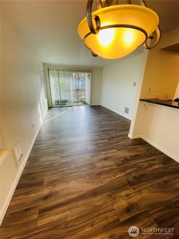 a view of room and hall with wooden floor