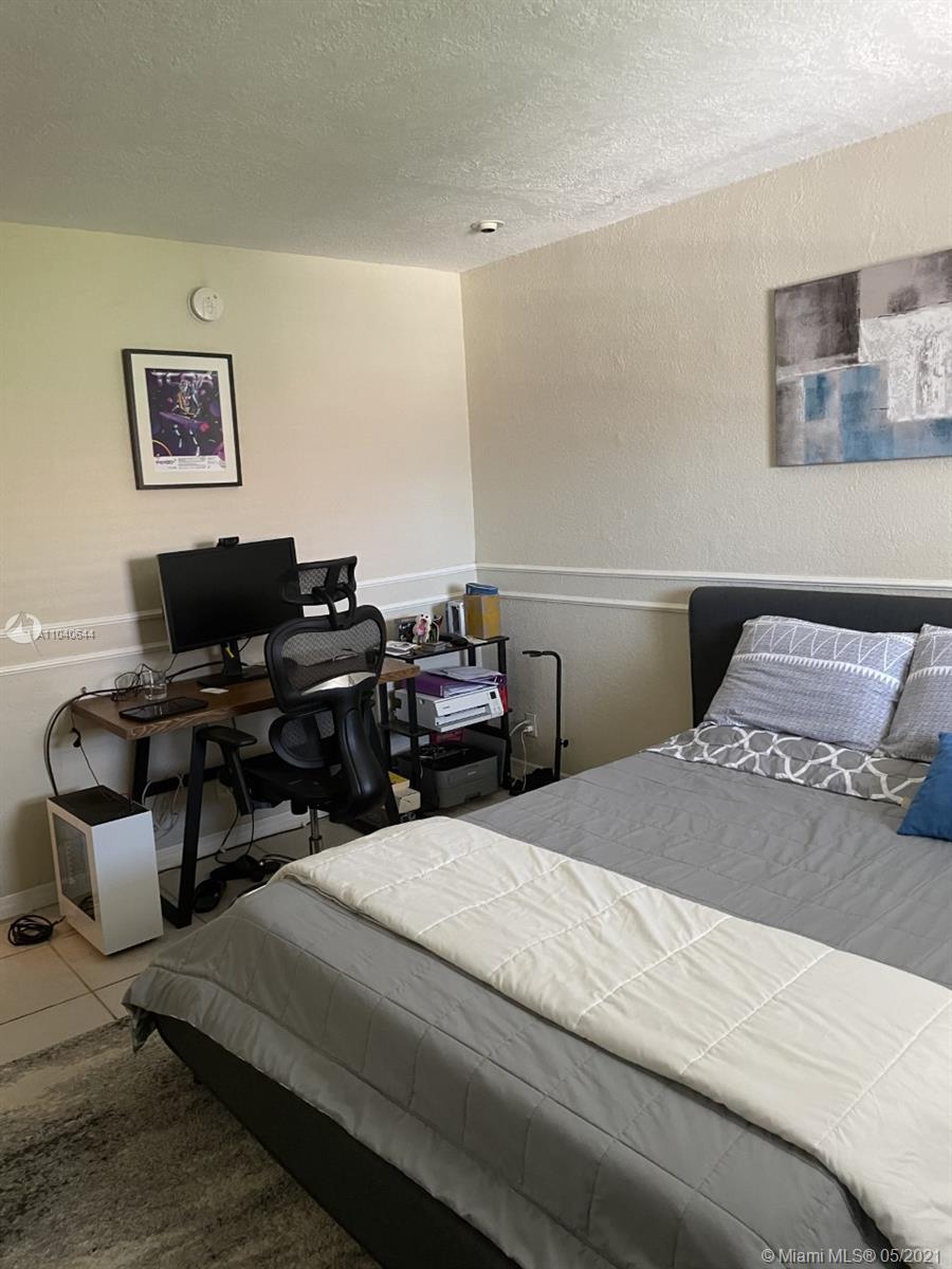 6709 North Kendall Drive, Unit 222 Pinecrest, FL 33156 - Photo 2 of 23 a bedroom with a bed and couch