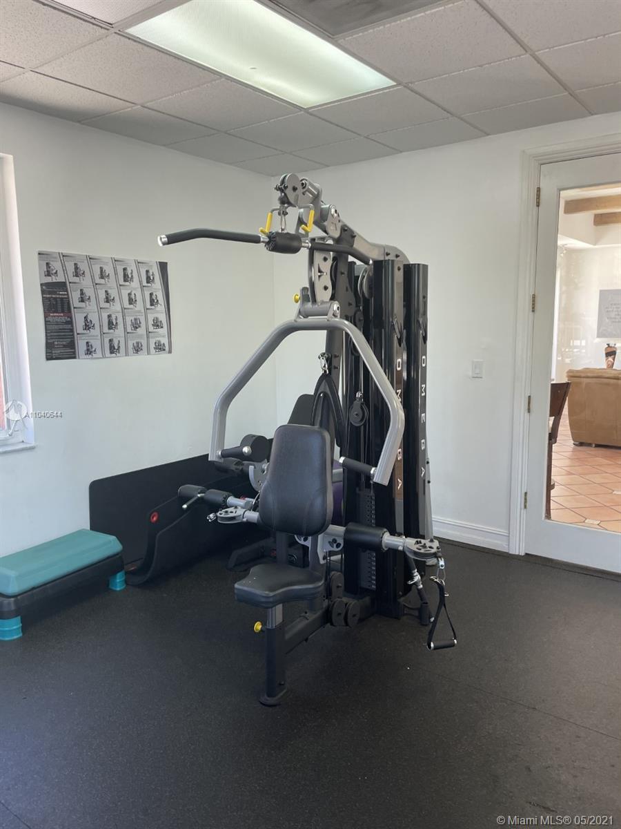 6709 North Kendall Drive, Unit 222 Pinecrest, FL 33156 - Photo 15 of 23 a room with gym equipment and a mirror