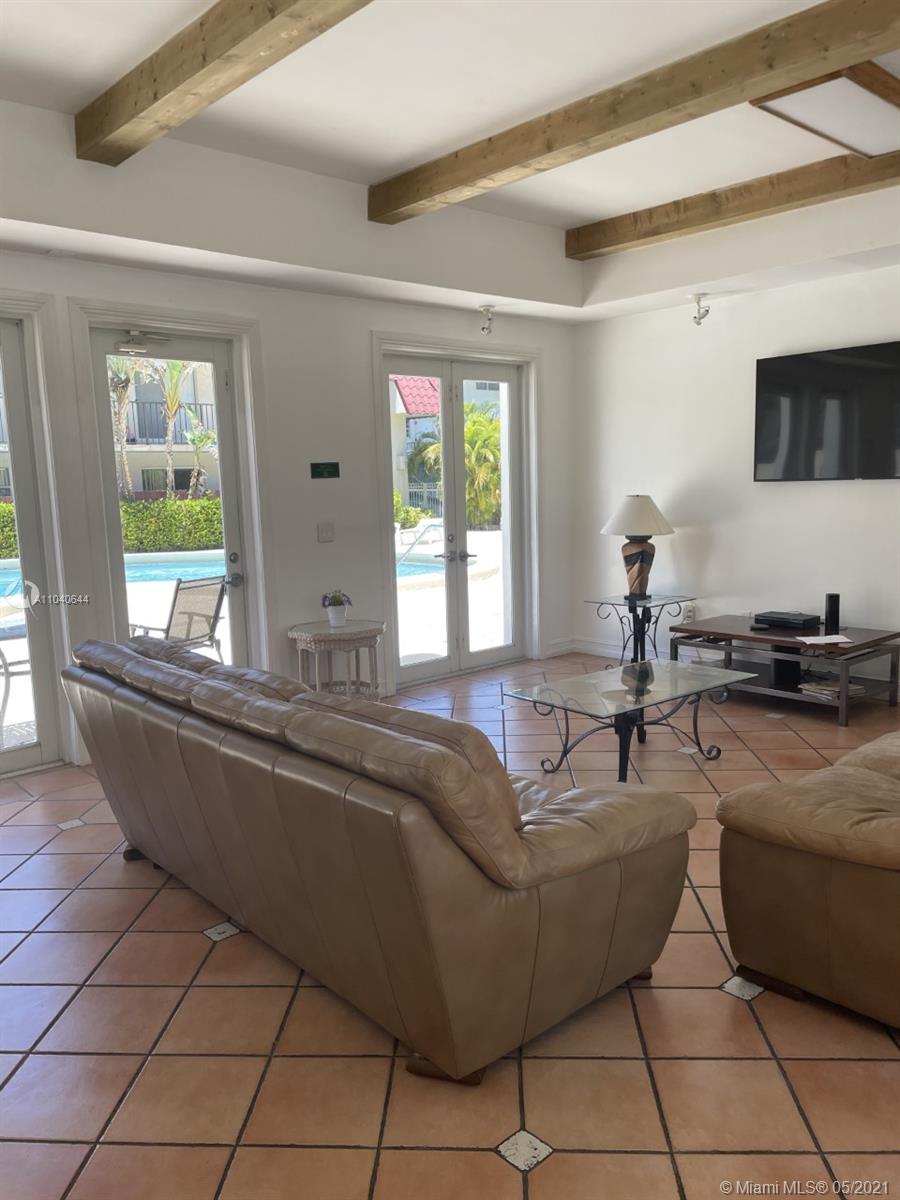 6709 North Kendall Drive, Unit 222 Pinecrest, FL 33156 - Photo 18 of 23 a living room with furniture and a flat screen tv