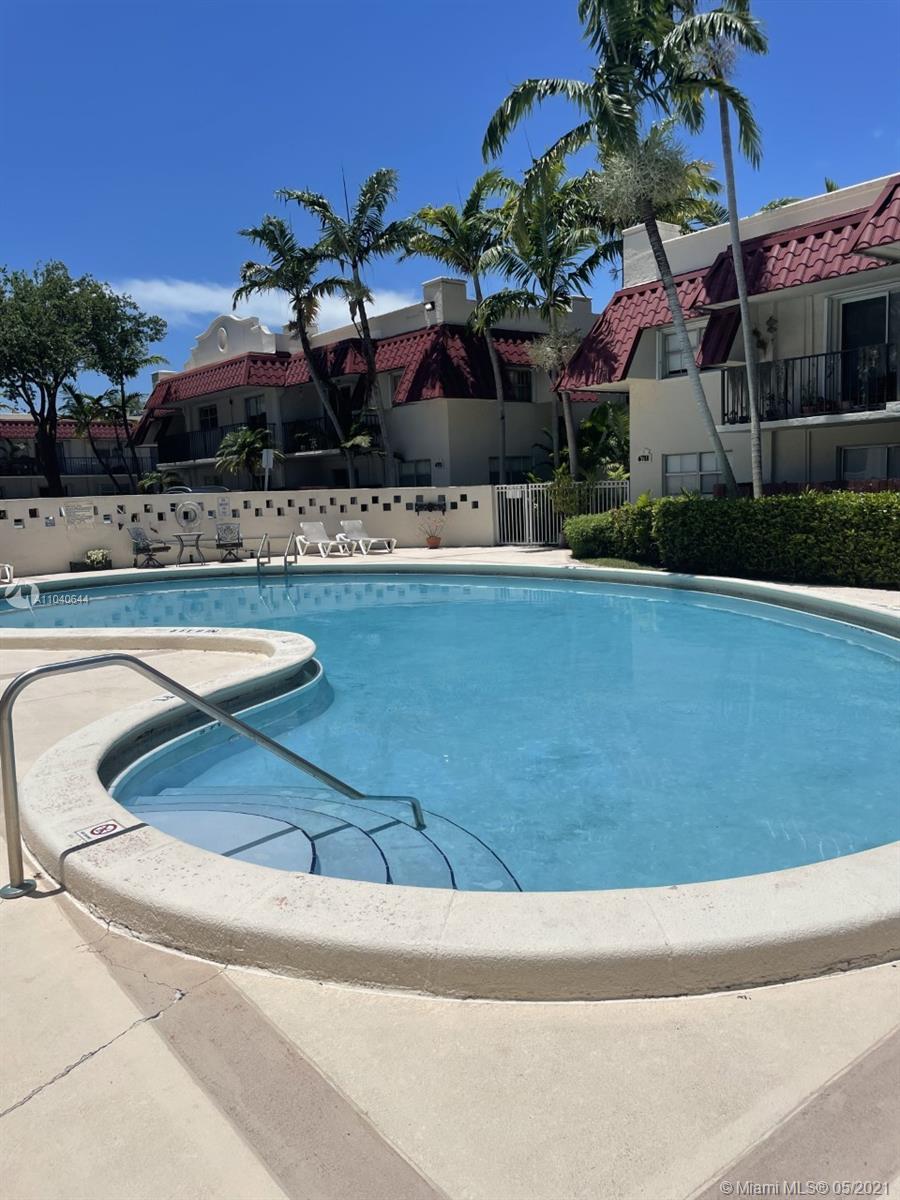 6709 North Kendall Drive, Unit 222 Pinecrest, FL 33156 - Photo 19 of 23 a front view of a house with swimming pool