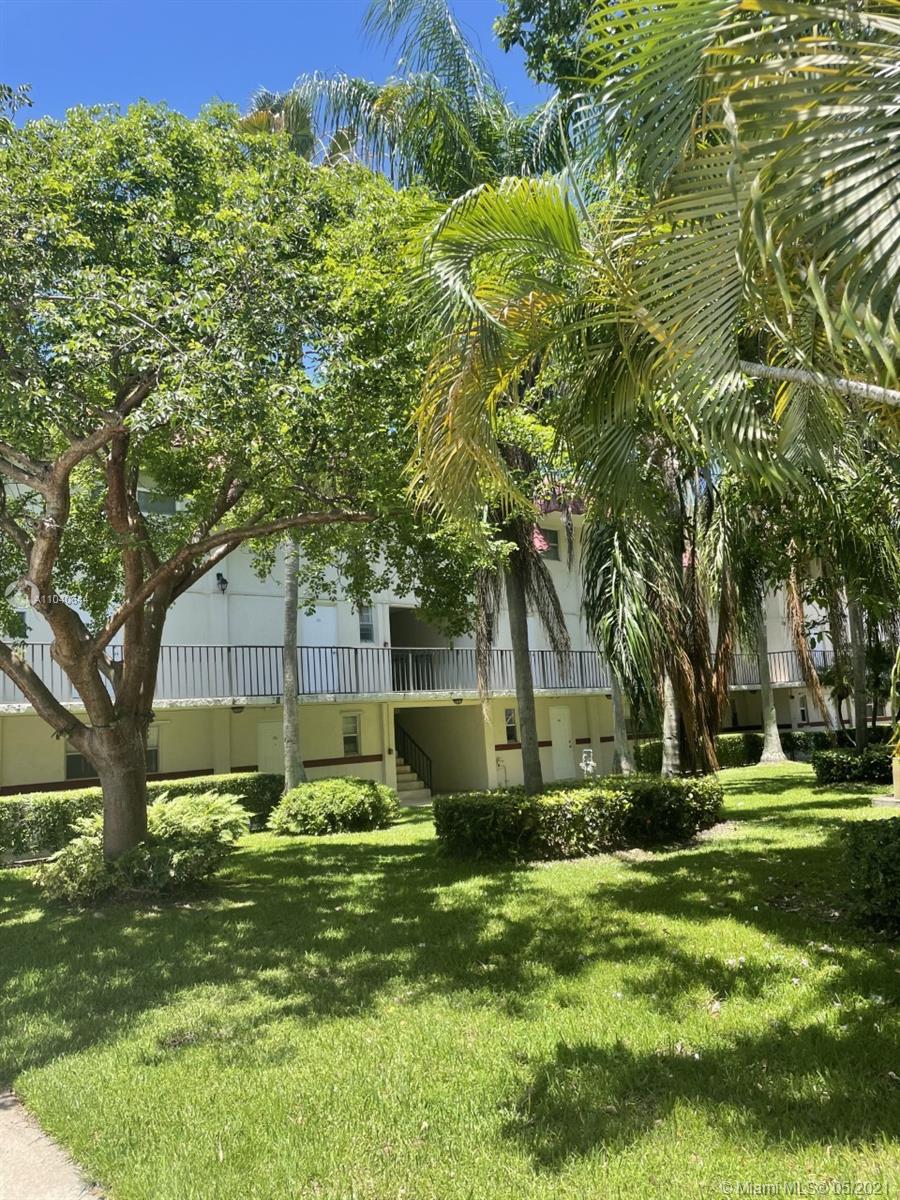 6709 North Kendall Drive, Unit 222 Pinecrest, FL 33156 - Photo 20 of 23 a backyard of a house with lots of green space and fountain