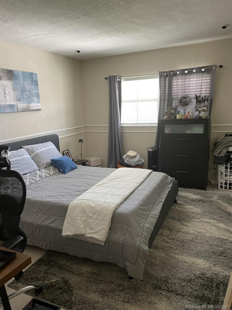 6709 North Kendall Drive, Unit 222 Pinecrest, FL 33156 - Photo 3 of 23 a bedroom with a bed and dresser