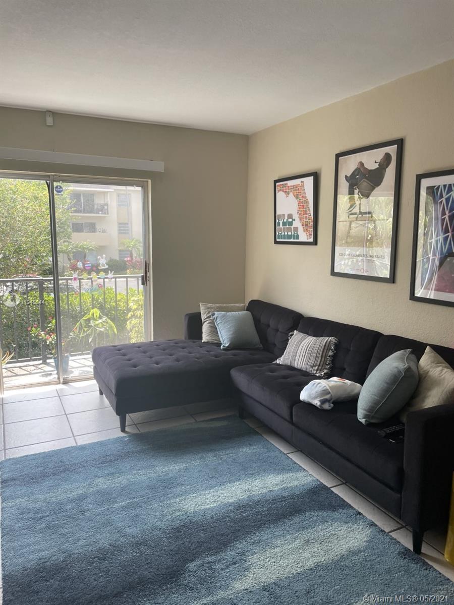6709 North Kendall Drive, Unit 222 Pinecrest, FL 33156 - Photo 7 of 23 a living room with furniture and a large window