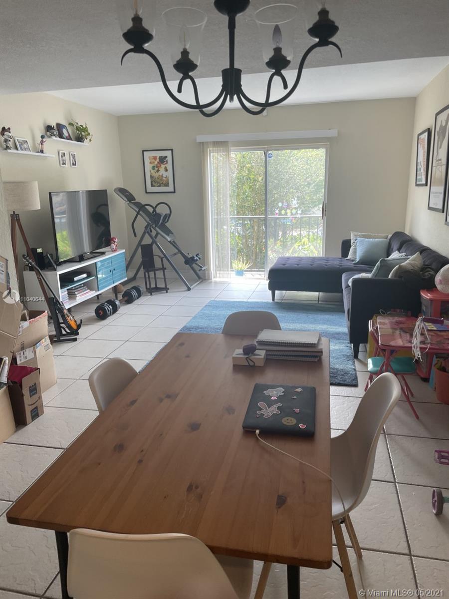6709 North Kendall Drive, Unit 222 Pinecrest, FL 33156 - Photo 8 of 23 a living room with furniture a air conditioner and a window
