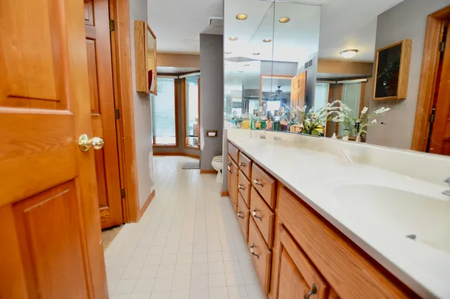 a bathroom with a toilet sink and mirror