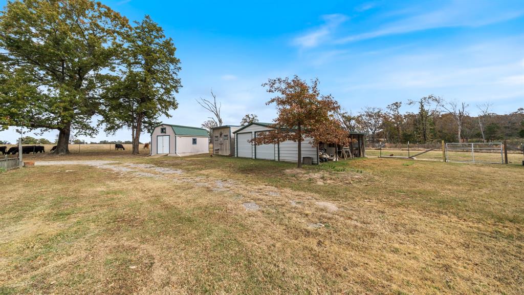 460 VZ County Road Canton, TX 75103 - Photo 7 of 24 View of yard with an outdoor structure, a pole building, and a gate