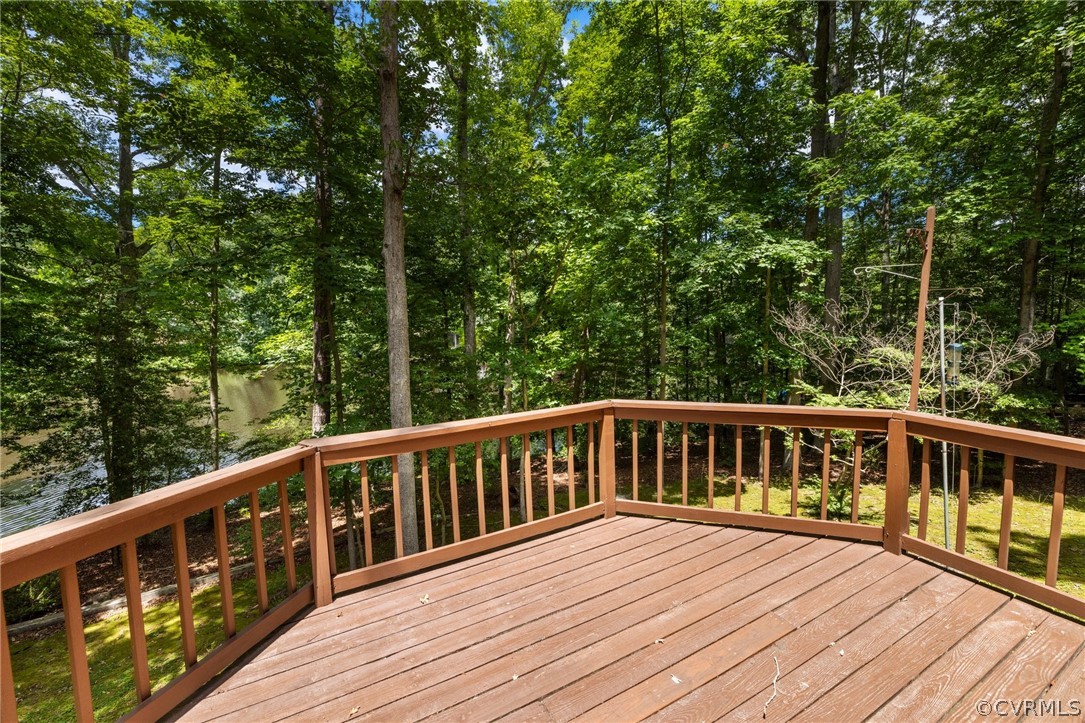 4534 Forrestal Road Chester, VA 23831 - Photo 14 of 39 a balcony with wooden floor and fence