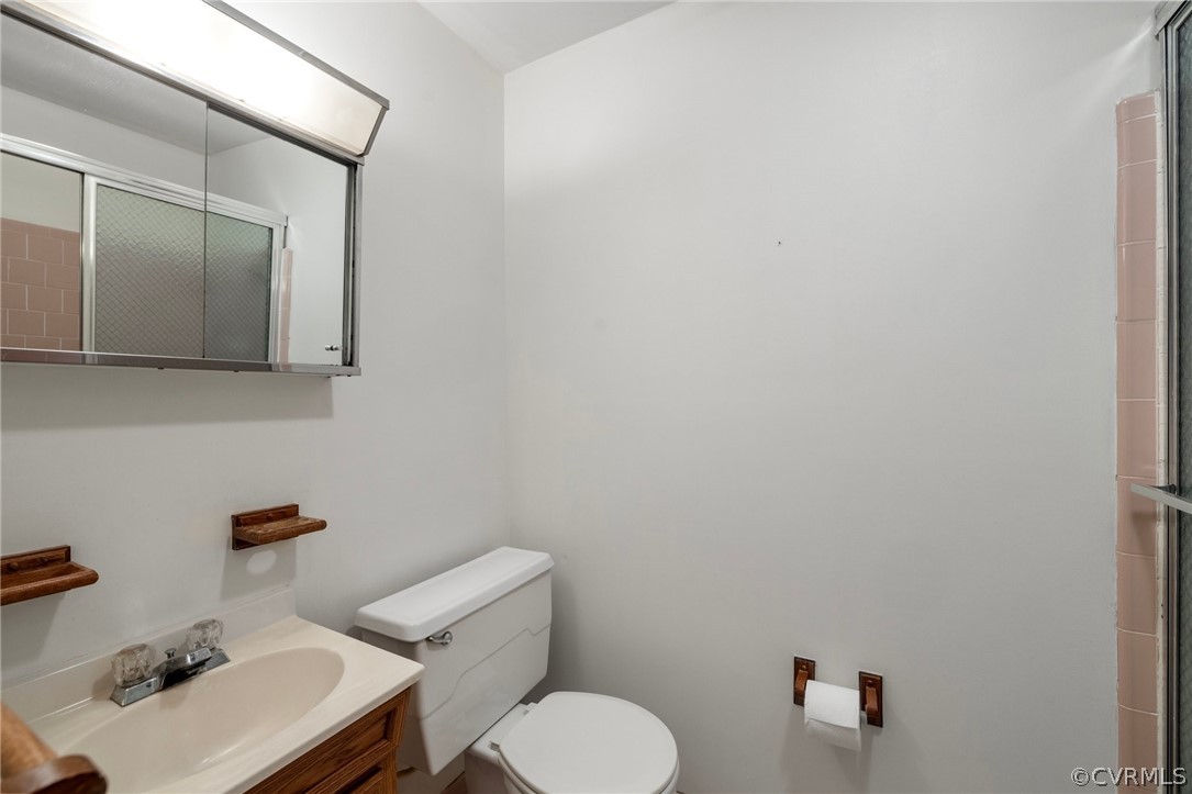 4534 Forrestal Road Chester, VA 23831 - Photo 28 of 39 a bathroom with a sink mirror and toilet