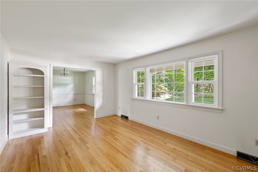 4534 Forrestal Road Chester, VA 23831 - Photo 4 of 39 a view of an empty room with a window and wooden floor