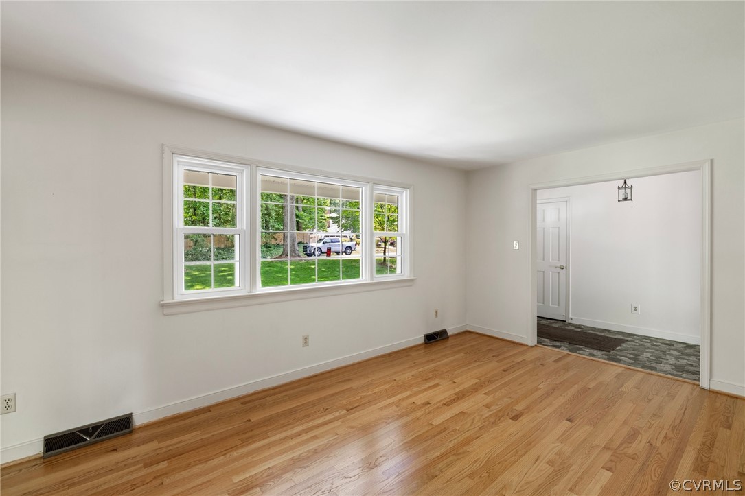 4534 Forrestal Road Chester, VA 23831 - Photo 5 of 39 an empty room with wooden floor and windows