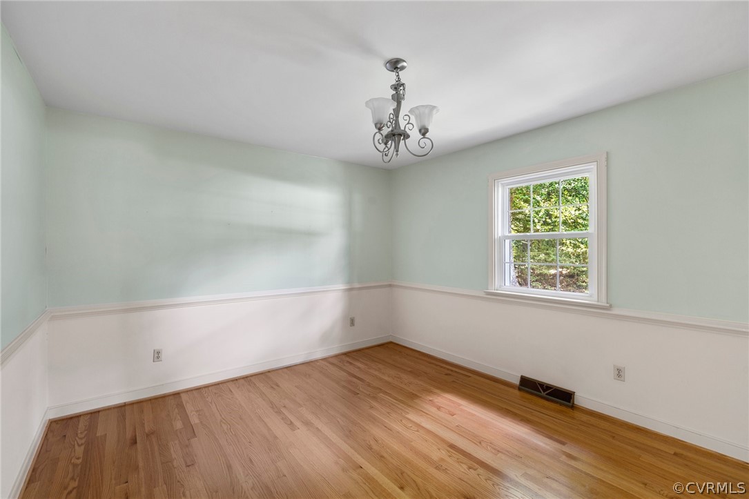 4534 Forrestal Road Chester, VA 23831 - Photo 6 of 39 an empty room with wooden floor and windows