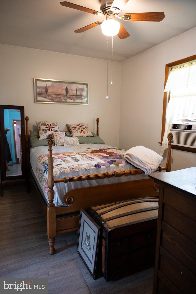 31858 River Park Road Millington, MD 21651 - Photo 9 of 14 a bed room with a bed and a chandelier