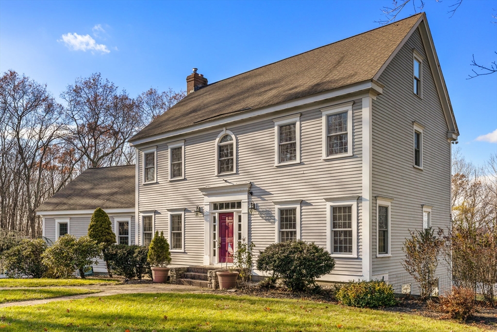 a front view of house with yard and green space