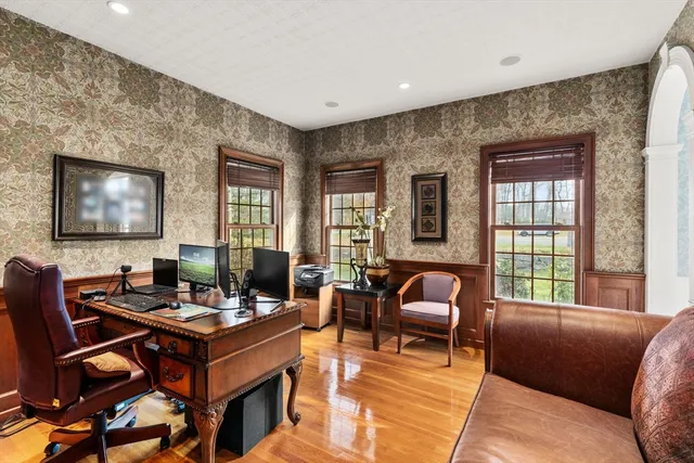 a living room with furniture and two windows