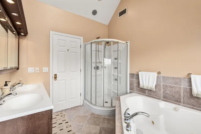 a bathroom with a granite countertop sink a toilet and shower