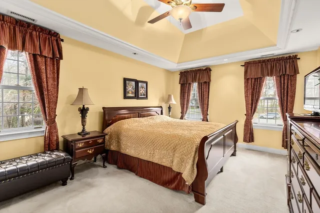 a bedroom with a bed couch and a window