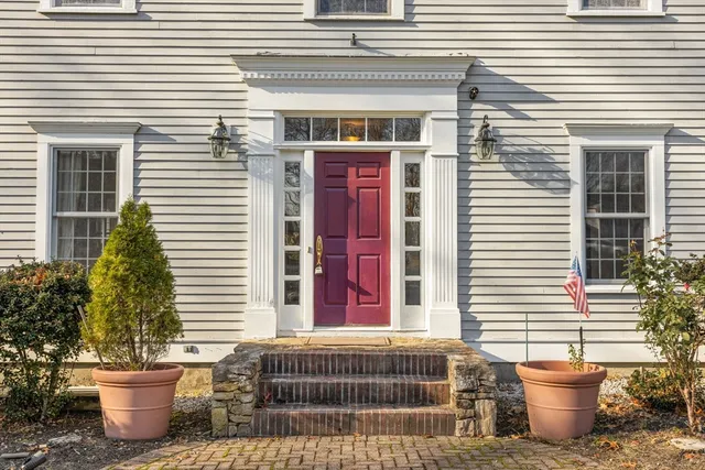 a front view of a house with plants
