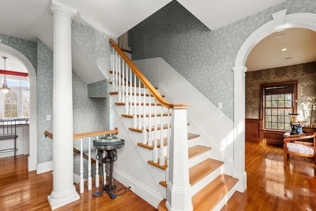 a view of entryway with wooden floor and stairs